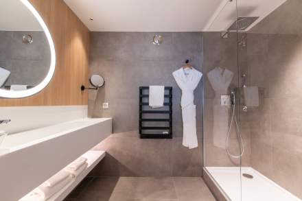 Grande salle de bain avec une baignoire à lHôtel de la Paix, hôtel 4 étoiles au centre-ville de Reims, proche de la Gare de Reims